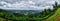 A landscape panorama of green hills with cloudy sky on the background in Coorg, India