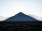 Landscape panorama view of Licancabur cone shaped volcano mountain silhouette Bolivia Chile Andes South America