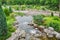 Landscape Park.Waterfall, bridge. Beautiful ornamental plants and trees.