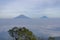 Landscape photo of mountain taken from highland with tree and bushes foreground