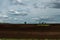 Landscape photo of plowed fields with small islands of forest