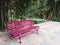 Landscape photo of The red wooden long seat is placed in the garden as a relaxing place to sit after exercising