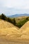 Landscape photo of the soil without vegetation, rough and cracked in the area of â€‹â€‹muddy volcanoes, Buzau, Romania, geological