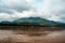 A landscape pictures of the shores of the mekong river in south vietnam near vinh long on a sunny summer day. Mountain in clouds.