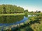 Landscape on the pond of of small park with birches grow.