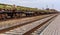 Landscape with railroad track and chain of cargo wagons