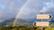 Landscape rainbow with signposts. Life direction metaphor.