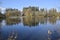 Landscape with reflection in clear, smooth, calm water.