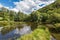 Landscape with reflection of water, clouds, forest, trees