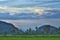 Landscape of Ricefields With Hills, Trees and Waterway on a Cloudy Afternoon