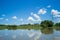 Landscape of river and blue sky with cloud. High voltage tower