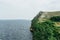 Landscape river cliff grass on the sky background