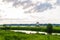 Landscape of a river delta with a tugboat and a dredger in the background