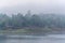 Landscape of river and houseboat with morning mist