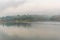 Landscape of river and houseboat with morning mist