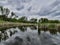 landscape river, sky, reeds. beautiful reflection of trees in the water