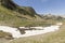 Landscape with a river and snowfields in the Ordina Arcalis area in Andorra