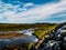 Landscape with Rivers, blue sky with clouds, green plants and hills in Iceland