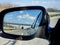 Landscape and road reflection in car rearview black mirror.