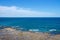 landscape of rock coast line beach deep blue ocean with beautiful clear sky, copy space on ocean