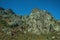 Landscape with rocky cliffs covered by green bushes