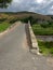 Landscape with a rocky country road over the old bridge