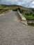 Landscape with a rocky country road over the old bridge