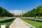 Landscape with round crown trees Robinia pseudoacacia Black Locust, False Acacia and white fasade stadion