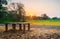 Landscape of a rustic manmade bench for relaxing with sunset in the background, Tranquil environment image of bench with no person