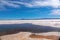 Landscape of Salar de Uyuni in Bolivia covered with water, salt flat desert and sky reflections