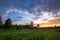 Landscape of sanset of summer field under blue sky with clouds