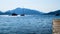 Landscape of sea and mountains with the boats and the jetty.