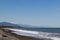 landscape with sea and mountains. Waves and rocky shore.