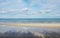 Landscape of sea and water surf to beach with coconut tree shadow in cloudy day