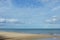 Landscape of sea and water surf to beach with coconut tree shadow in cloudy day