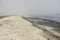 Landscape with seagulls,  sea view with breakwaters,  waves and sea shells,  clouds,  photographed in Gura Portitei,  Romania,  in