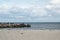 Landscape with seagulls,  sea view with breakwaters,  waves and sea shells,  clouds,  photographed in Gura Portitei,  Romania,  in