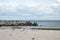 Landscape with seagulls,  sea view with breakwaters,  waves and sea shells,  clouds,  photographed in Gura Portitei,  Romania,  in