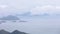 Landscape and seascape mountain and the sea and shipping cargo containers in the rain season at viewpoint ngong ping 360 cable car