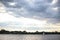 Landscape seascape view of cloudy sky and one lonely boat yach floating in calm river