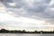 Landscape seascape view of cloudy sky and one lonely boat yach floating in calm river