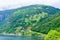 Landscape of the serpentine Eagles Road, rising along the slope of the mountain above the Geirangerfjord near the village of