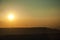 Landscape and several wind turbines silhouettes on sunset