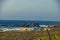 Landscape shot of a beautiful rocky coastline and undulating ocean in harmony with blue sky