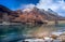 Landscape shot of a calm frozen lake surrounded by valleys and mountains during the day