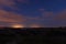 Landscape shot of the night sky with stars and clouds and the ocean in the background