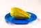 Landscape shot of a pear squash vegetable placed on a blue plate