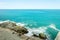 Landscape shot of sea and sky near a rocky corner.