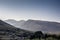 Landscape shot or view of mountains in the early morning with sunlight and flair over it.