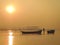 Landscape showing a lonely boatman on the Ganges river at sunrise in the city of Allahabad, India.